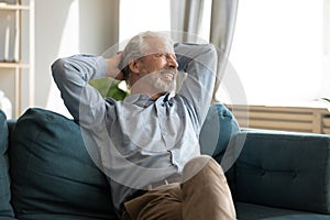 Relaxed happy mature old man enjoying free lazy weekend time.