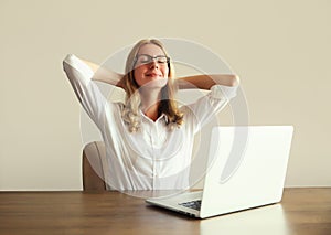 Relaxed happy woman take a break working with laptop sitting at desk in office or home