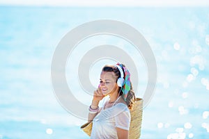 Relaxed healthy woman listening to music on seacoast