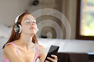 Relaxed homeowner listening to music at home