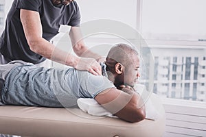 Relaxed international man visiting rehabilitation procedure in clinic