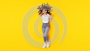 Relaxed Lady Singing Listening Music Wearing Headphones Over Yellow Background