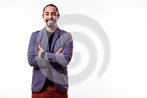 Relaxed Latin businessman with arms crossed on a white background