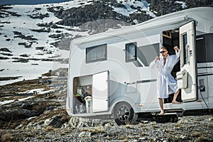 Relaxed Man Drinking Coffee In His Camper Van Doors During Mountain Wilderness RV Road Trip