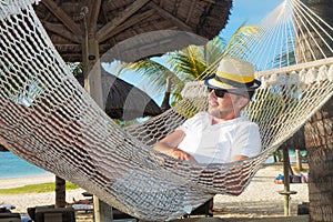 Relaxed man in a hammock on the beach