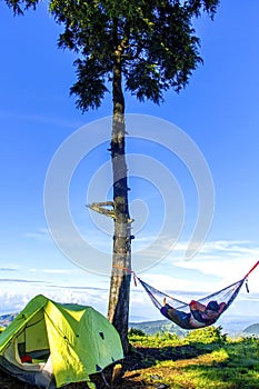 Relaxed man and lying in a comfortable hammock