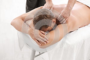 Relaxed man receiving back massage