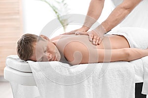 Relaxed man receiving back massage