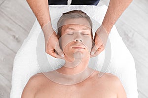 Relaxed man receiving head massage