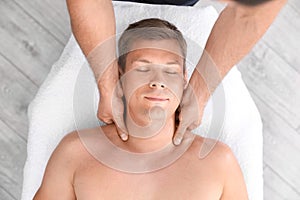 Relaxed man receiving head massage