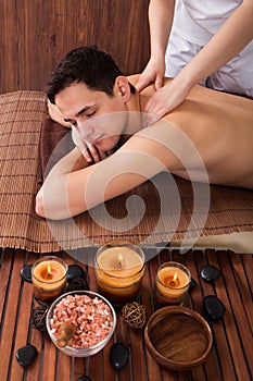 Relaxed Man Receiving Shoulder Massage In Spa