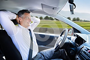 Relaxed Man Sitting In Self Driving Car