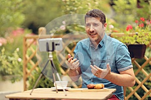 Relaxed manager discussing business strategies with his team on video call. Young casual business owner at a table having a video