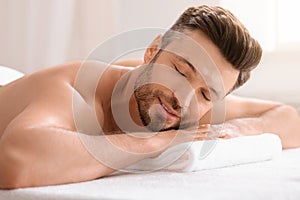 Relaxed middle aged man attending spa salon