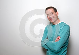 Relaxed middle aged man smiling with arms crossed