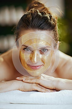 relaxed modern woman in massage cabinet laying on massage table