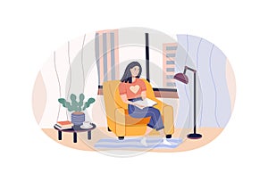 Relaxed modern woman reading paper book sitting on armchair at comfortable home