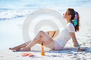 Relaxed modern woman sitting on seacoast