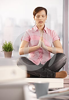 Relaxed office worker meditating