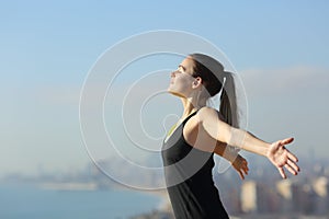 Relaxed runner breathing fresh air in city outskirts