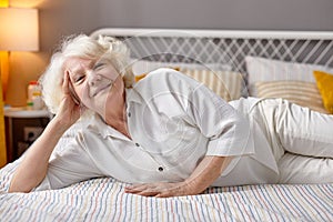 Relaxed Senior Woman Lying On Bed At Home, Spend Weekends Alone