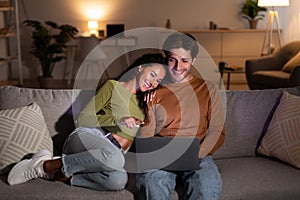 Relaxed Spouses Enjoying Movie Online On Laptop Relaxing At Home