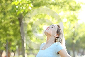 Relaxed teenage girl breathing fresh air in a park