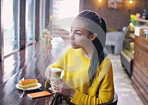 Relaxed teenage girl enjoying her coffee break