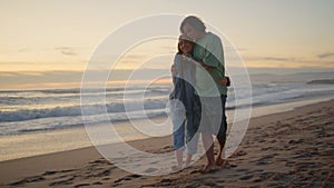 Relaxed teenagers walking sunset beach. Romantic sweethearts kissing at ocean