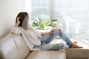 Relaxed thoughtful woman enjoying wellbeing dreaming at luxury l