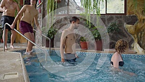 Relaxed Tourists Getting Into A Hot Tub