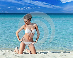 Relaxed woman in bikini enjoying tropical beach and caribbean summer vacation.