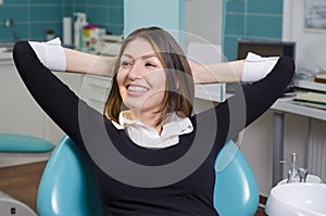 Relaxed woman with braces in dentist chair