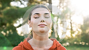 Relaxed woman breathing fresh air outdoors