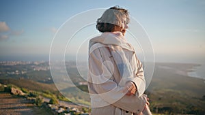 Relaxed woman contemplating coastal evening feeling serenity happiness closeup.