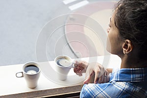 Relaxed woman drinking a cup of coffe in the morning