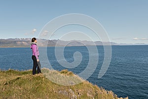 Relaxed woman enjoying sun, freedom and life an beautiful beach in Iceland