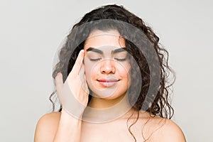 Relaxed woman feeling her face after a beauty spa