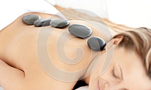 Relaxed woman with hot stones on her back