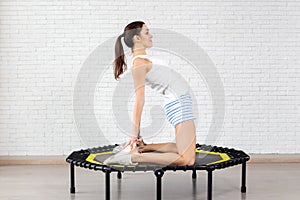 Relaxed woman jumping on trampoline.