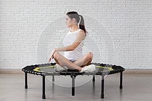 Relaxed woman jumping on trampoline.