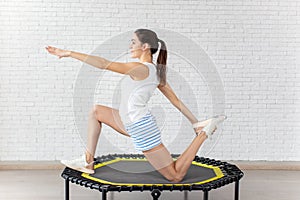 Relaxed woman jumping on trampoline.