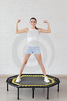 Relaxed woman jumping on trampoline.