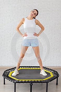 Relaxed woman jumping on trampoline.