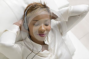 Relaxed Woman Listening To Music On Portable CD Player