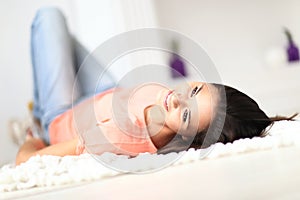 Relaxed woman lying on the floor indoors