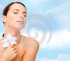 Relaxed woman with orhid flower