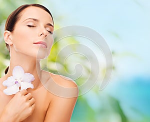 Relaxed woman with orhid flower