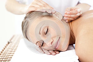 Relaxed woman receiving an acupuncture treatment