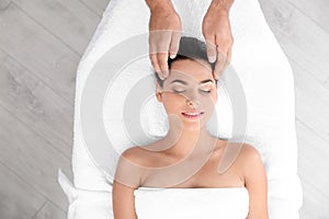 Relaxed woman receiving head massage